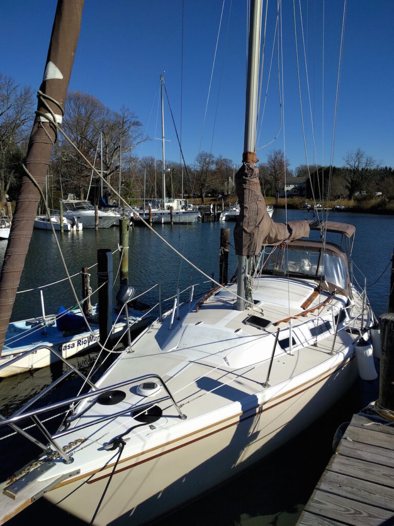 Biege Catalina 30 sailboat in the water