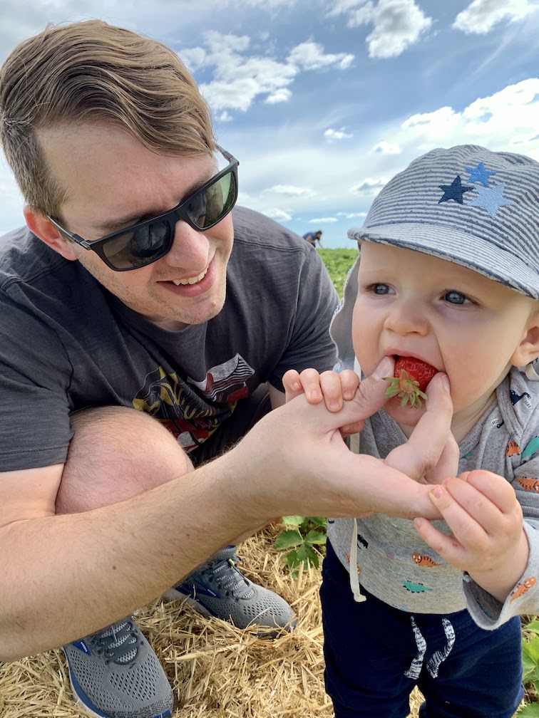 Alex feeding a strawberry to Orion